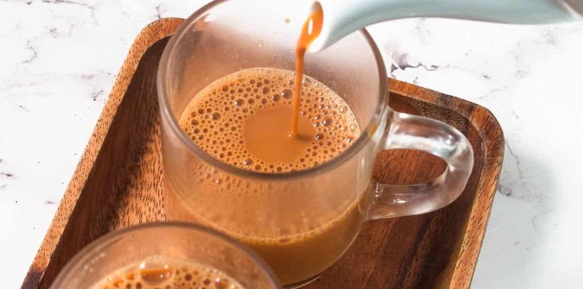Comparing a cup of traditional Karak tea with a glass of organic green tea Dubai UAE