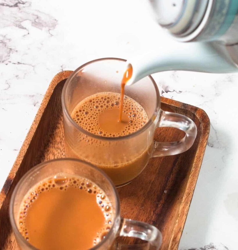 Comparing a cup of traditional Karak tea with a glass of organic green tea Dubai UAE
